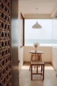 a table and a chair in front of a window at Meli Beach in Galle