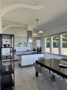 a kitchen and dining room with a table and chairs at Exceptional house by Lake Geneva in Versoix