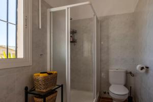 a bathroom with a shower and a toilet in it at Casa Mira in Cómpeta +11 photos