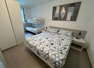 a small bedroom with a bed and a chair at 67 Bellaria Bilocale vicino al mare in Bellaria-Igea Marina