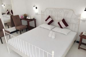 a bedroom with a white bed and a chair at W Hotel Mount Lavinia - Colombo in Colombo