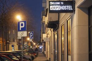 a street with cars parked on the street at Jopi Hostel Katowice Centrum in Katowice