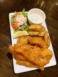a plate of food with chicken tenders and a salad at Melvo's Homestay in Puerto Princesa City +26 photos