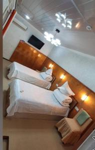 two beds in a small room with lights at Umid Hostel in Qŭnghirot