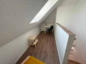 an attic room with a desk and a chair at Spreewälder Ferienpension in Lübben