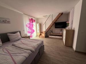 a bedroom with a bed and a flat screen tv at Spreewälder Ferienpension in Lübben