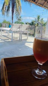 a drink in a glass sitting on a table at The ransi House in Dickwella