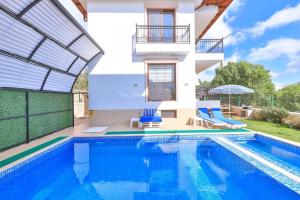 a villa with a swimming pool and a house at Villa Mars in Kaş