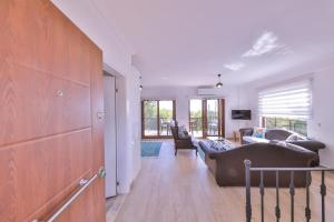 a living room with a couch and a table at Villa Mars in Kaş