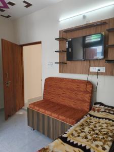 a small room with a bed and a microwave at Janki Guest House in New Delhi