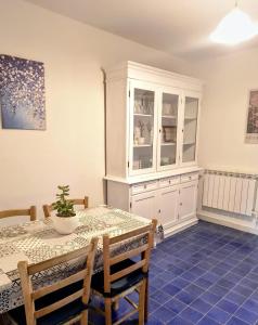 a dining room with a table and a white cabinet at Tana di Zia Nature, Yourself, Love in Viggianello