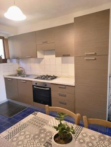 a kitchen with a table with a plant on it at Tana di Zia Nature, Yourself, Love in Viggianello