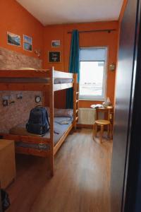 a bedroom with two bunk beds and a desk at Jopi Hostel Katowice Centrum in Katowice