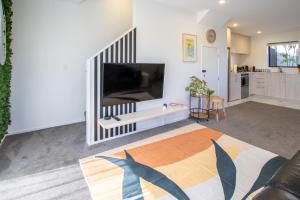 a living room with a large flat screen tv at Charming 2-Bedroom Apartment - 2 BR, 1 Bath in Christchurch