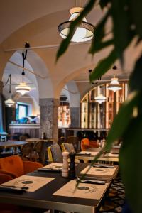 a dining room with tables and chairs and lights at ROYAL ROOMS*** in Ljubljana +27 photos