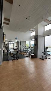 a gym with a lot of treadmills and machines at Sky High City View 2BR Corner Condomonium in Pulau Sembakau Kecil