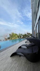 a balcony with a view of a swimming pool at Sky High City View 2BR Corner Condomonium in Pulau Sembakau Kecil