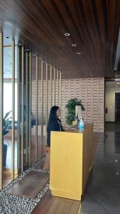 a woman sitting at a counter in an office at Sky High City View 2BR Corner Condomonium in Pulau Sembakau Kecil +54 photos