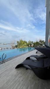 a resort with a swimming pool next to the water at Sky High City View 2BR Corner Condomonium in Pulau Sembakau Kecil