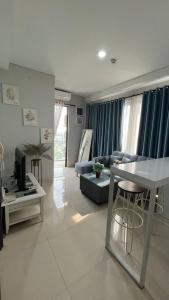 a living room with a couch and a table at Sky High City View 2BR Corner Condomonium in Pulau Sembakau Kecil