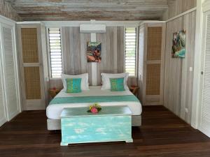a bedroom with a large bed in a room at FARE VAVAE in Tevaitoa