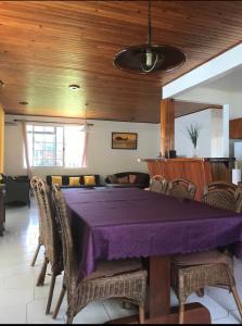 a dining room with a purple table and chairs at Mirimiri guest house in Tahu-Naoe