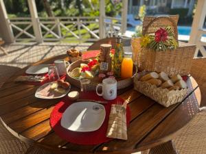 a wooden table with a table with breakfast foods on it at FARE VAVAE in Tevaitoa +7 photos
