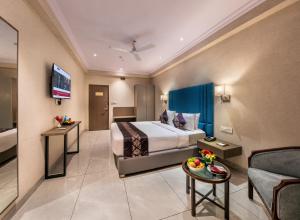 a hotel room with a bed and a couch at Lords Eco Inn Dahej in Dahej