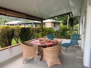 a patio with a table and chairs on a porch at FARE VAVAE in Tevaitoa