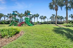 a playground at a park with palm trees at St. Lucia 802 in Destin