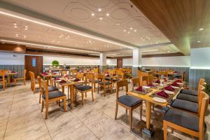 a dining room with wooden tables and chairs at Lords Eco Inn Dahej in Dahej