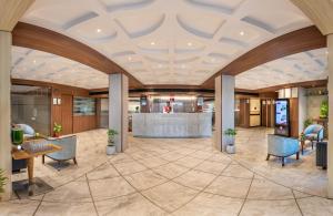 a rendering of a lobby with tables and chairs at Lords Eco Inn Dahej in Dahej