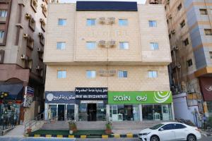 a car parked in front of a hotel at Binayat Hama Serviced Apartments - Standard in Al Jubail