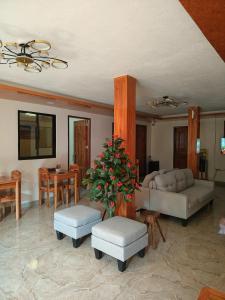 a living room with a couch and a table at Natalie's Homestay Bed and Breakfast in El Nido