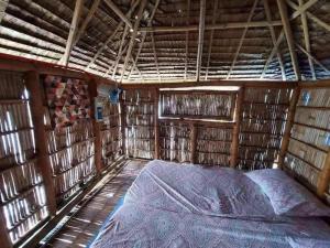 a bedroom with a bed in a room with many books at Satosa Beach Resort in San Joaquin +94 photos
