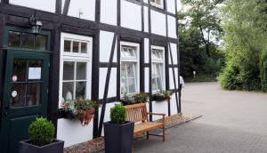 a bench in front of a building with windows at Schlichte Hof GmbH in Bielefeld