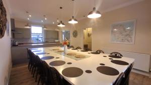 a dining room table with a polka dot table cloth at Woodlands in Benllech