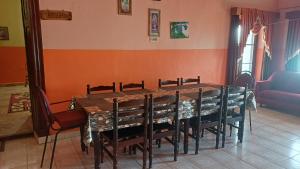 a dining room with a table and chairs at Cliff Club Resort Ooty in Ooty