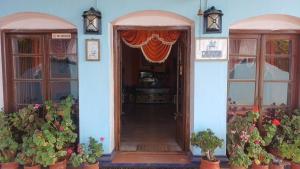 an entrance to a house with a curtain on the door at Cliff Club Resort Ooty in Ooty