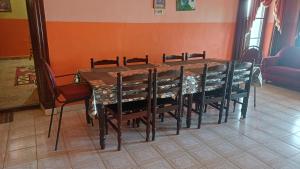 a dining room table with chairs and a table at Cliff Club Resort Ooty in Ooty +52 photos