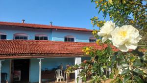 a house with white flowers in front of it at Cliff Club Resort Ooty in Ooty
