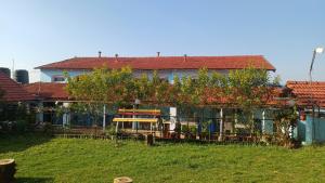a house with a fence and trees in front of it at Cliff Club Resort Ooty in Ooty
