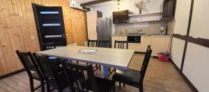 a kitchen with a table and chairs in a room at Casa Anda in Azuga