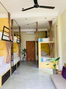 a room with four bunk beds and a ceiling at Layday Surf Ahangama in Ahangama