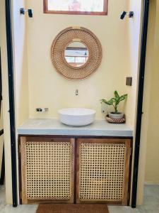 a bathroom with a sink and a mirror on the wall at Layday Surf Ahangama in Ahangama