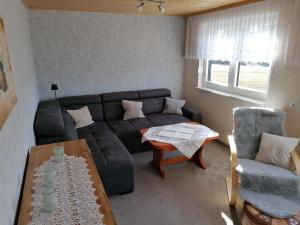 a living room with a couch and a table at Ferienhaus Lisa in Klingenthal