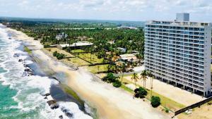 an aerial view of a beach with a large building at Joansa Luxury Beachfront Apartment in Uswetakeiyawa