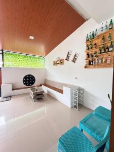 a living room with blue chairs and a window at The Heaven Luxe Pangandaran in Pangandaran