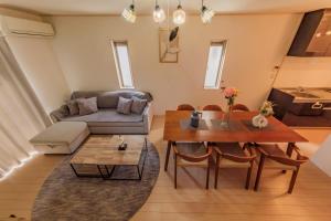 a living room with a couch and a table at ｾ-ﾇeast in Takasaki