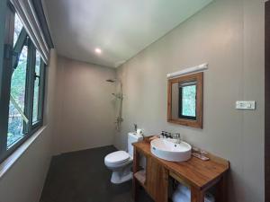 a bathroom with a sink and a toilet at Ancarine Beach Resort in Phú Quốc